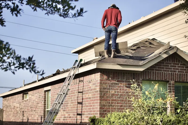 Professional roofer working on a residential roof in Blackland